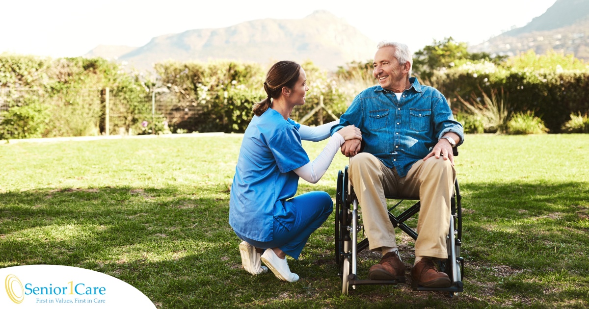 Caregivers like this one talking to a smiling senior patiently and compassionately help clients and help them with aging in place while dealing with different conditions.