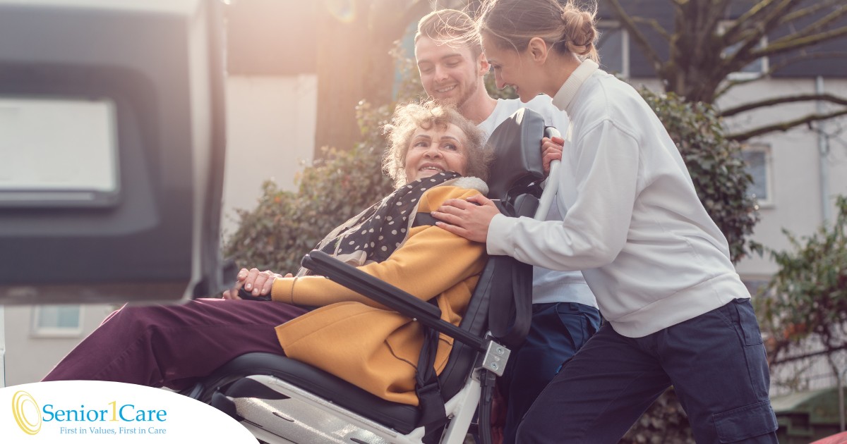 2 caregivers help an older adult get into a vehicle using a ramp, showing how equipment is valuable to professional caregivers when helping older adults.