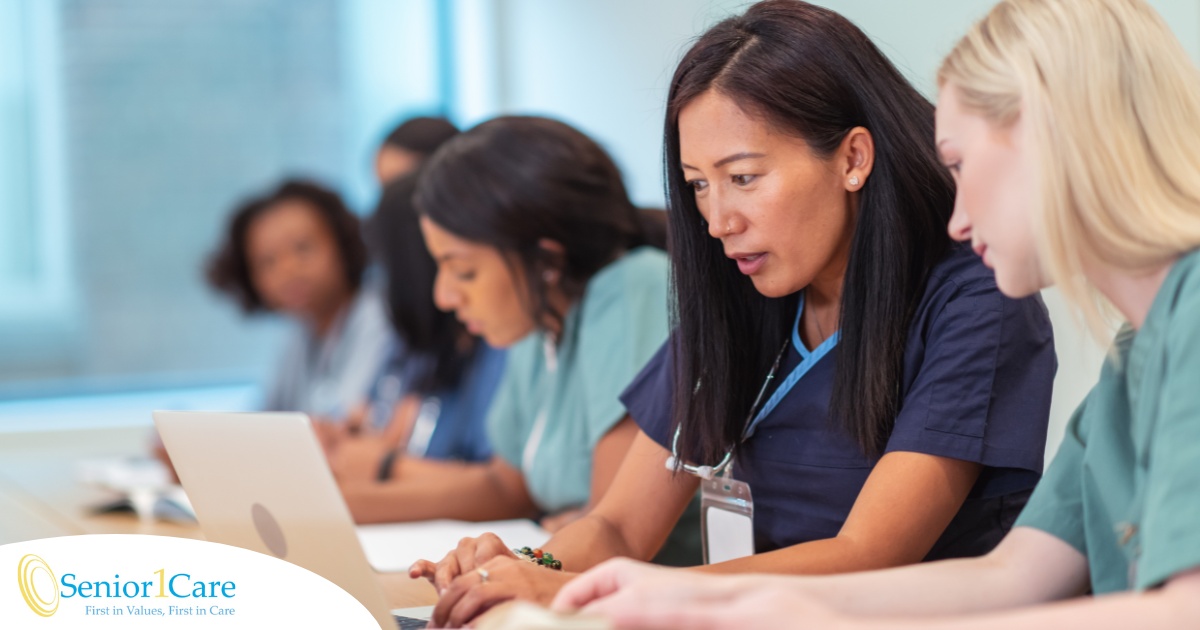 2 nursing students in a class study on a computer together, showing part of what is needed to be a registered nurse.