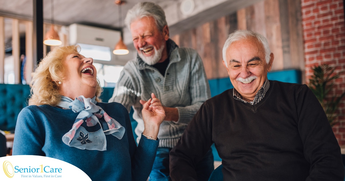 Older adults laugh and enjoy each other’s company representing how socialization can help seniors.