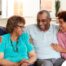 A couple sits with aging parents and enjoys their time together.