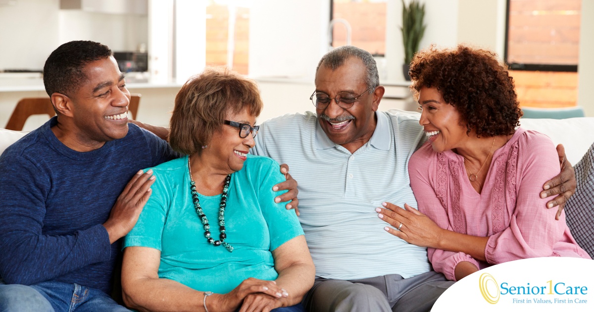 A couple sits with aging parents and enjoys their time together.