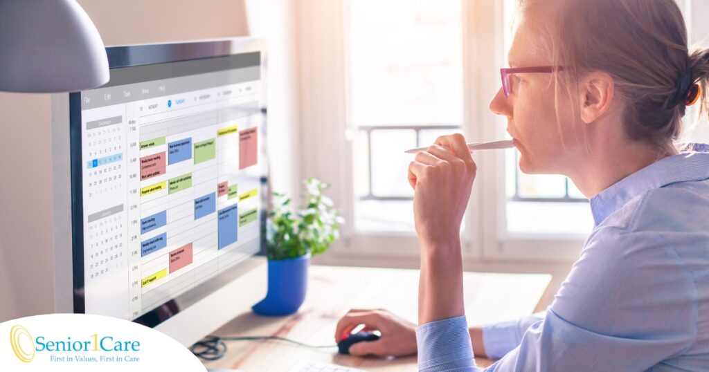 A woman looks at her calendar on her computer, showing an example of a time management tool that can help caregivers.