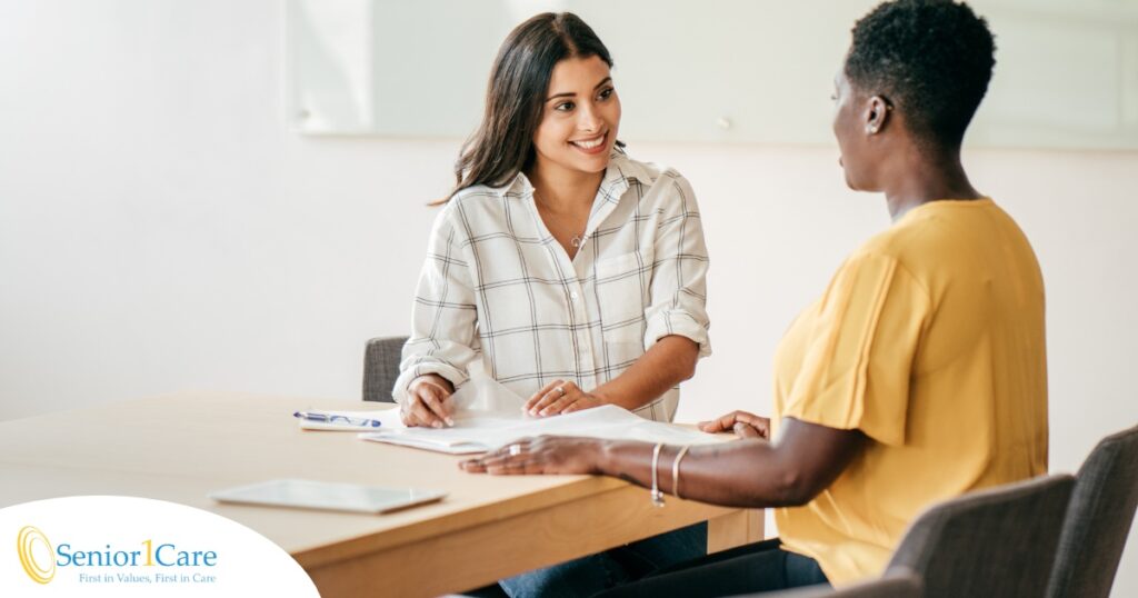 A woman smiles while being interviewed representing how well a caregiver interview can go when good questions are asked.