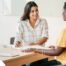 A woman smiles while being interviewed representing how well a caregiver interview can go when good questions are asked.